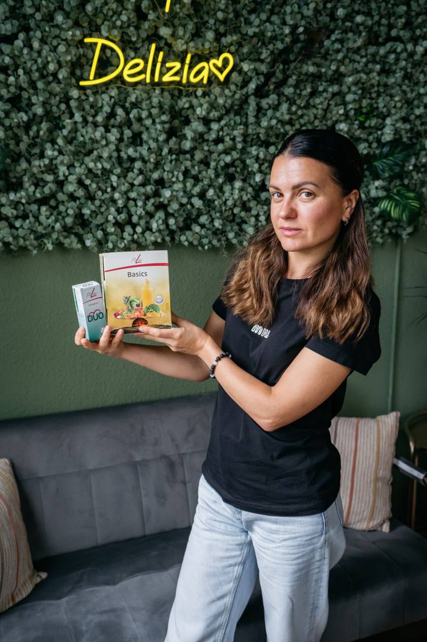 Milochka Zhukovskaya тримає набори продуктів FitLine